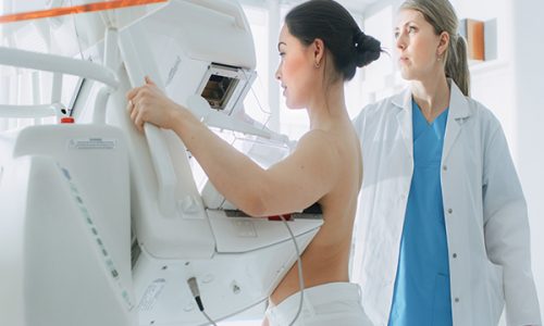 In the Hospital, Portrait Shot of Topless Female Patient Undergoing Mammogram Screening Procedure. Healthy Young Female Does Cancer Preventive Mammography Scan. Modern Hospital with High Tech Machines.